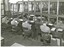 Boys typing on typewriter in class