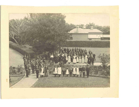 Entire school standing on lawn outside SKR