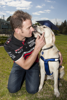 Will Davison with SEDA dog Davo with graduate cap
