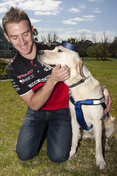 Will Davison with SEDA dog Davo with graduate cap