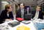 Lady, Chris Edwards and Bill Shorten view a PC