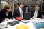 Lady, Chris Edwards and Bill Shorten view a PC