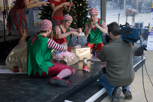 Camera person filming the elves wrapping presents