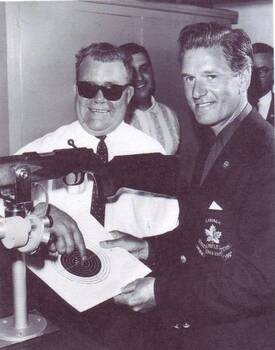 Fred Berry and his Canadian counterpart Dereck Daines with rifle and target