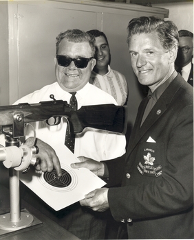 Fred Berry and his Canadian counterpart Dereck Daines with rifle and target