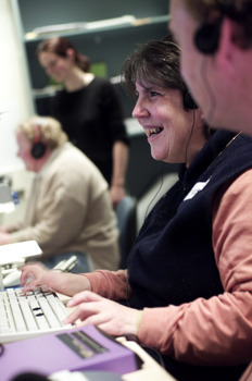 Woman wearing headphones as she types