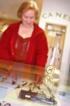 Woman with showcase of equipment in Assist shop