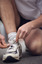 Male tying up laces on his running shoe