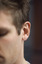 Side of a man's head with focus on the ear