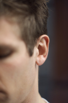 Side of a man's head with focus on the ear