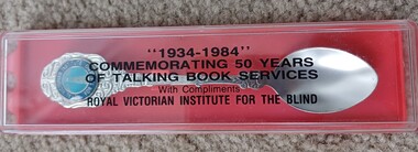 Metal teaspoon in box with inscription