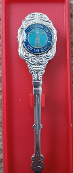 Metal teaspoon with RVIB logo on shaft of spoon handle