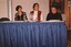 Unknown woman, Eve Lustig and Rebecca Maxwell sit at a table
