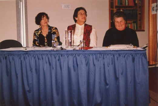 Unknown woman, Eve Lustig and Rebecca Maxwell sit at a table