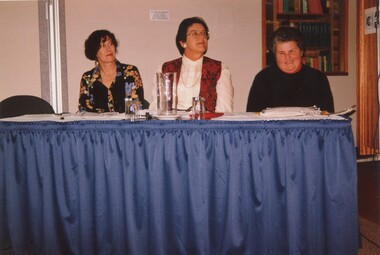 Unknown woman, Eve Lustig and Rebecca Maxwell sit at a table