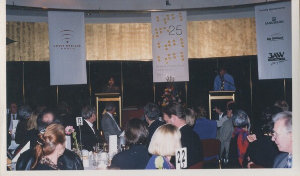 Ron Quantock and an unidentified woman at the podium in the Arts Centre
