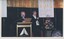Bib Stillwell and Mark Raphael Baker standing at the podium