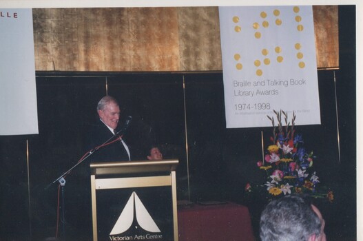 Bib Stillwell standing at the podium