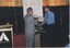 Rod Quantock presenting James Wright with a certificate of appreciation