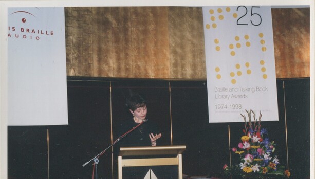Lisa Rodgers reads from the podium