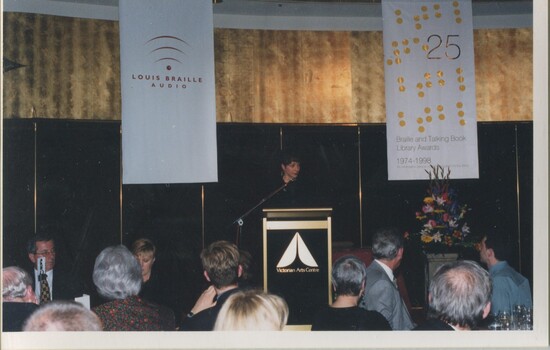 Lise Rodgers reads from the podium