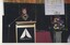 Deidre Rubenstein reads from the podium