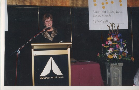 Deidre Rubenstein reads from the podium