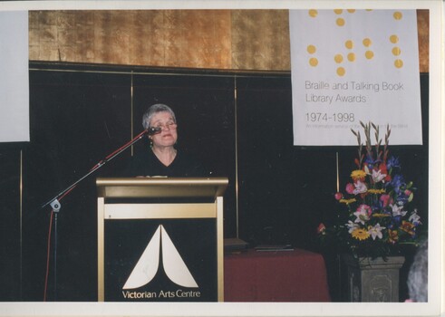 Beverley Dunn reads from the podium