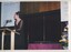 Caroline Lee reads from the podium