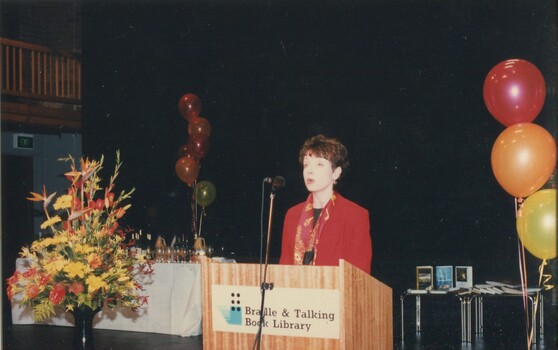 Lise Rodgers reads from the podium