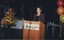 Cate Milte reads from the podium