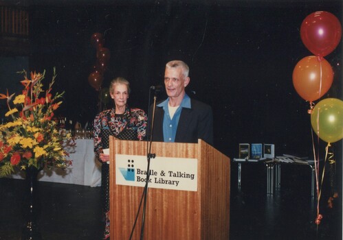 Robert Dessaix and unknown woman at podium
