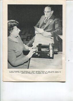 A female stenographer taking dictation using a Stainsby Braille writer