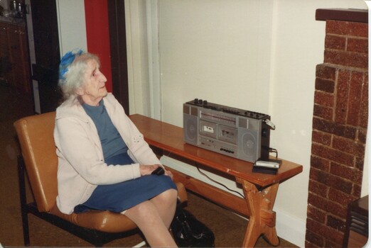 A lady listening to tapes on holiday