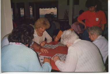 Bingo gamers watch their large print cards closely