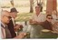 Four men sit around a table with cups of tea