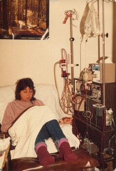 Woman reading in bed during dialysis