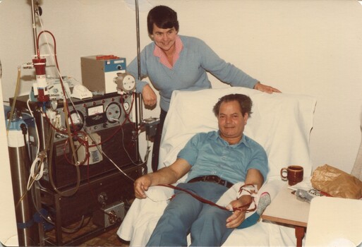 Luigi Demasi and Marg Brown with the Drake Willcock machine