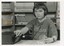 Child wearing headphones listening to a cassette player