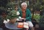 Claire Proctor with a talking book in a plant nursery