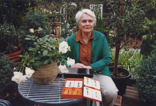 Claire Proctor with a talking book in a plant nursery