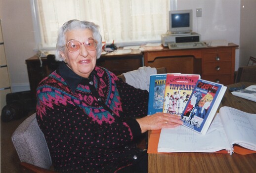 Older woman in office with LBA cassette titles