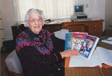 Older woman in office with LBA cassette titles