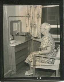 Woman touches the dial of a Clarke and Smith cartridge player