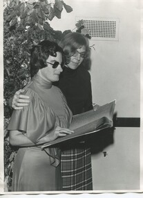 Kay White holds Braille book with Mary Rose Liverani beside her