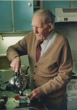 Man pours a kettle in his kitchen