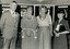 Four people stand in front of boards showing AFB activities