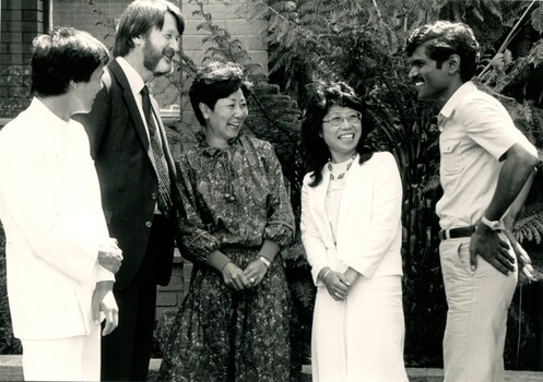 Five people chatting of various nationalities