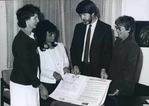 Murray Mountain and Shirley Admans looks at Proclamation with two women