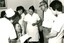 Group of nurses surround a man in a wheelchair